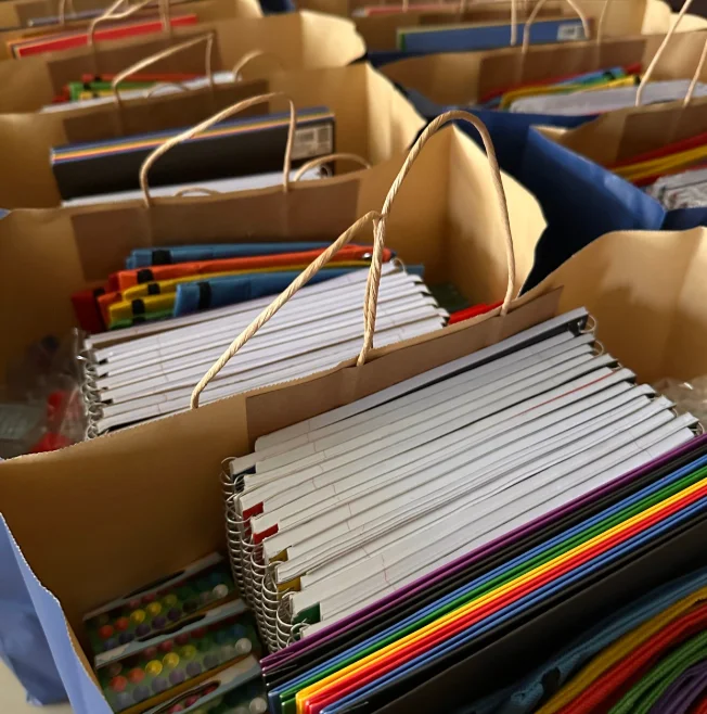 Colorful school supplies in bags