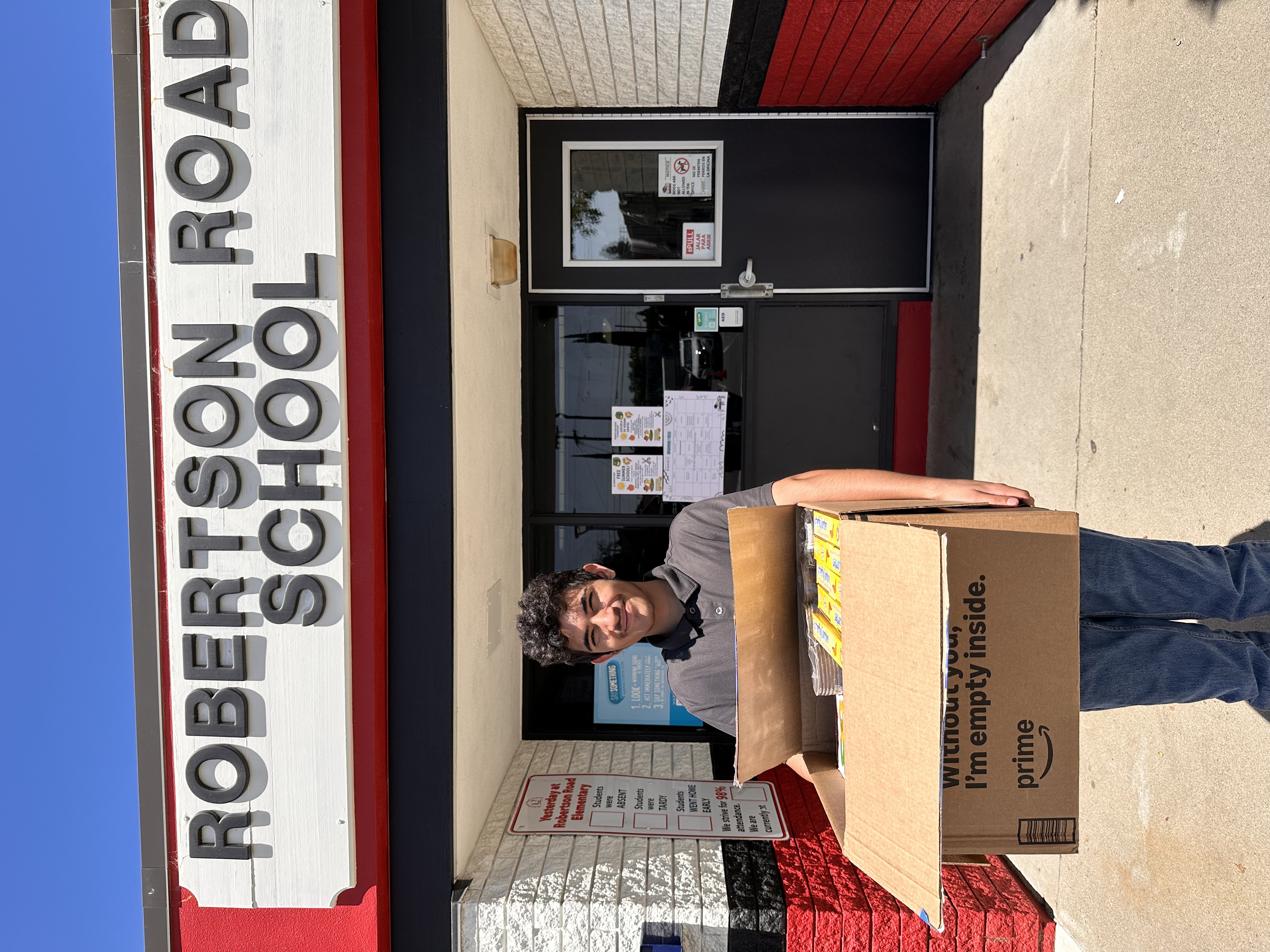 Volunteer delivering school supplies to Robertson Road Elementary