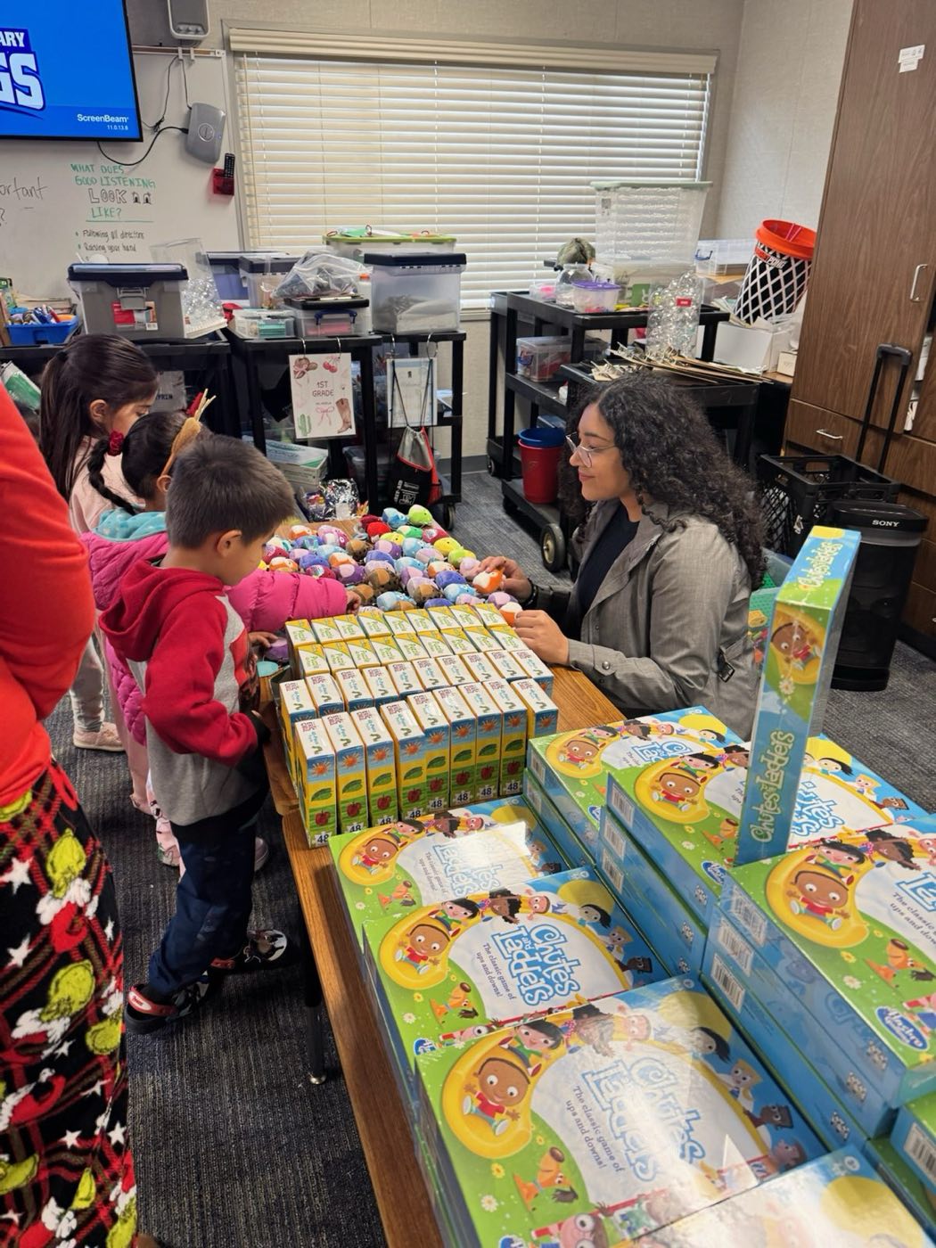 A volunteer helping children choose gifts at the holiday toy drive